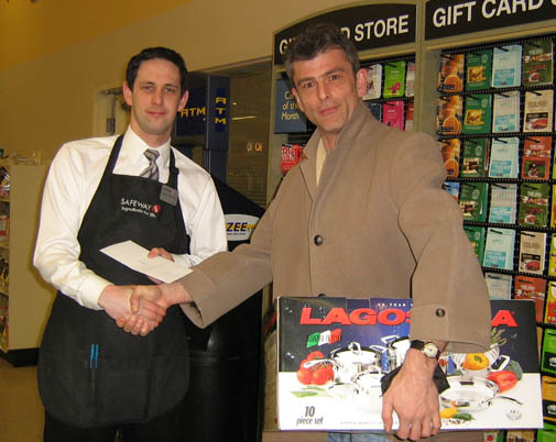 Image: Clerk handing over cookware set
